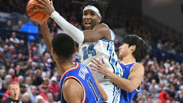 Jan 6, 2024; Spokane, Washington, USA; San Diego Toreros forward David Simon (14) rebounds the ball against Gonzaga Bulldogs forward Jun Seok Yeo (21) in the first half at McCarthey Athletic Center.